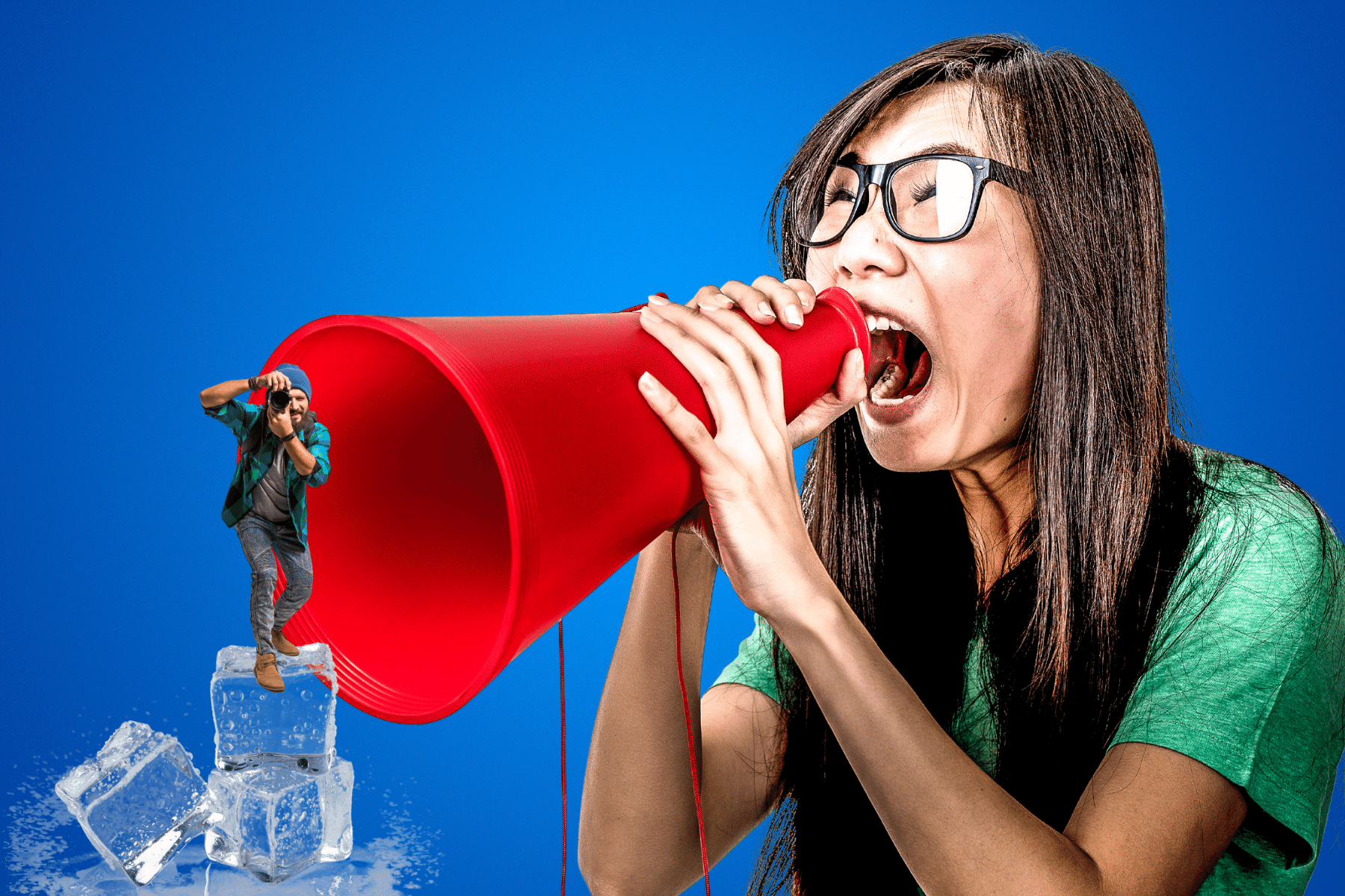 Woman in green shirt shouting through a red megaphone with a tiny man on ice cubes.