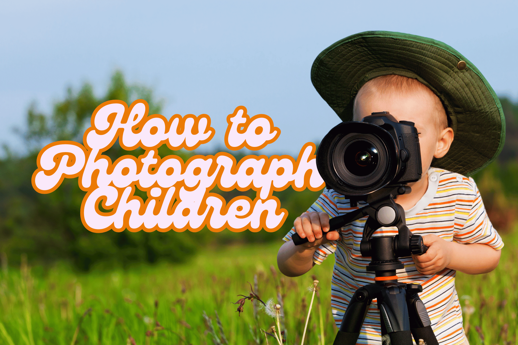 Child wearing a sun hat holding a camera on a tripod in a grassy field.