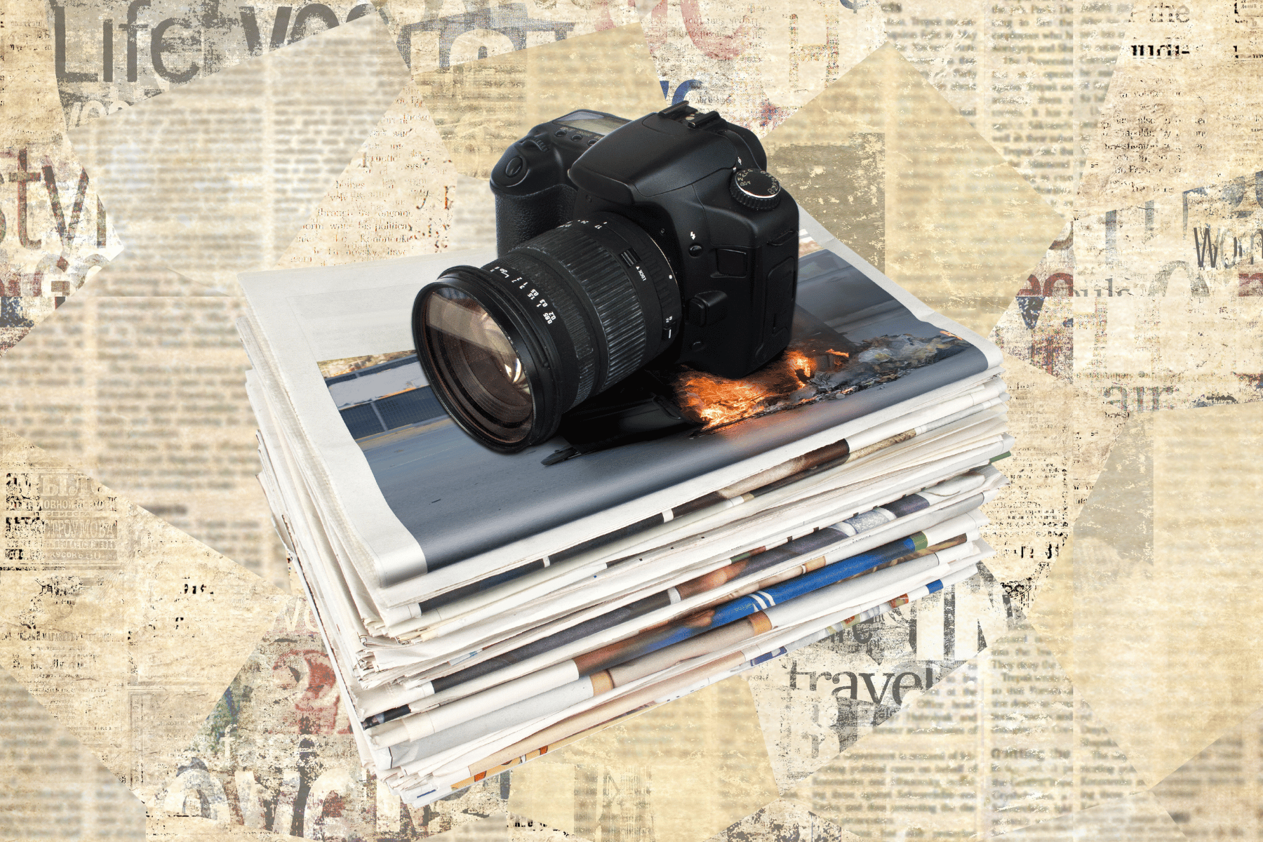 Black camera on top of stacked newspapers with a textured, vintage background.
