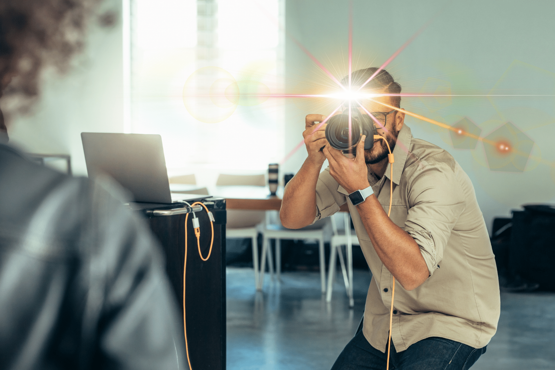 Man taking a photo with a camera and flash in a bright indoor setting.