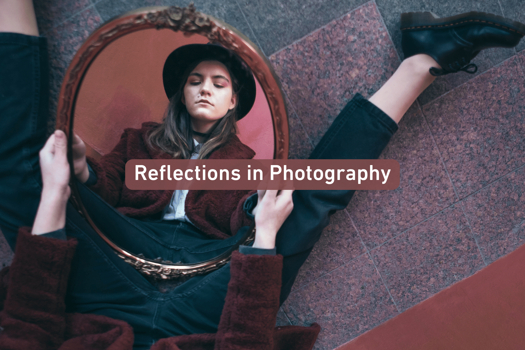 a person sitting on the ground holding a mirror, reflecting their face in a stylized setting
