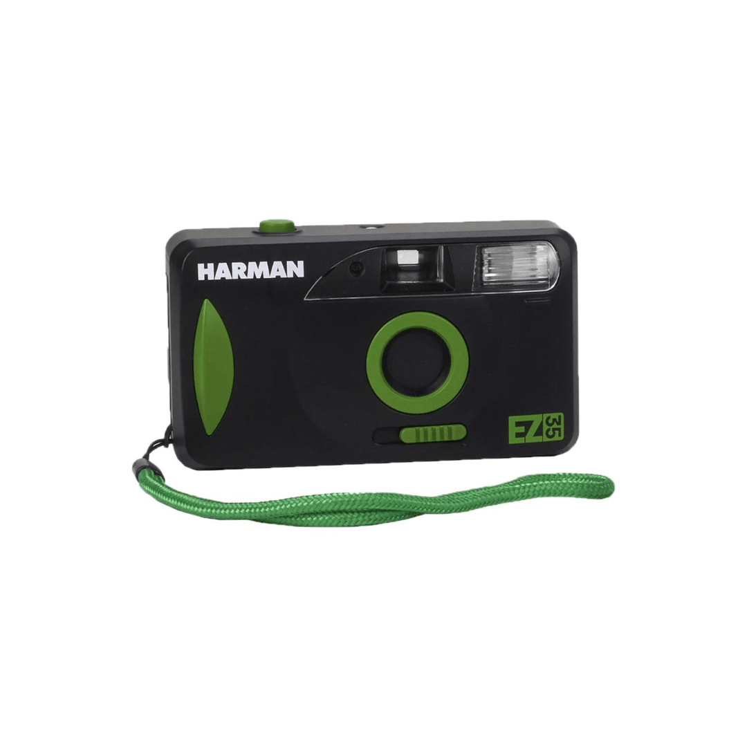 Black Harman 35mm film camera with green accents and a wrist strap.