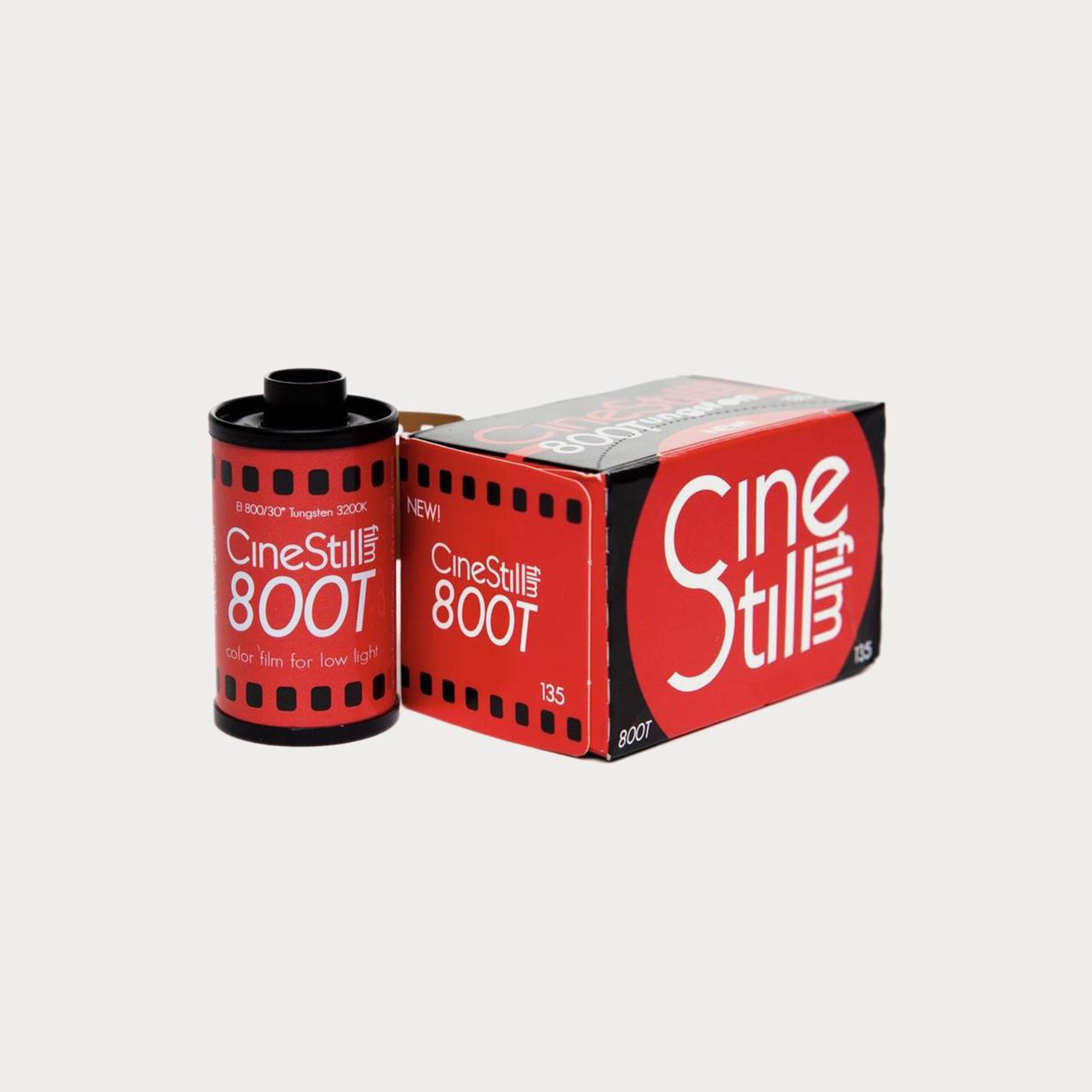 Red Cinestill 800T 35mm film canister next to its box, labeled 'NEW'.