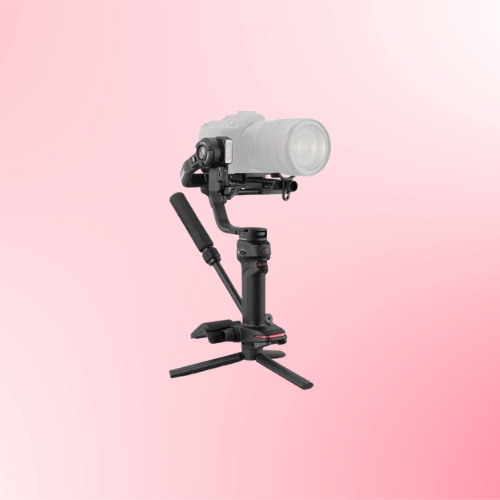 pink Zhiyun stabilizer with a camera mounted on it and a three-legged base.
