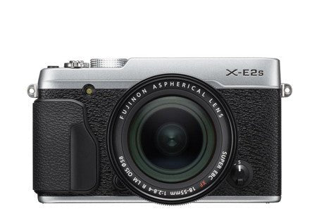 silver Fuji mirrorless camera with a black grip and a lens attached.