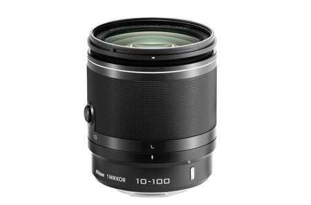 Black Nikon mirrorless lens with a zoom feature and green lens element.