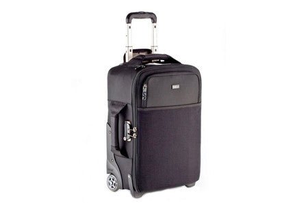 Black roller bag with retractable handle and silver zipper accents.